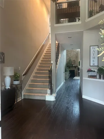 a view of entryway and hall with wooden floor