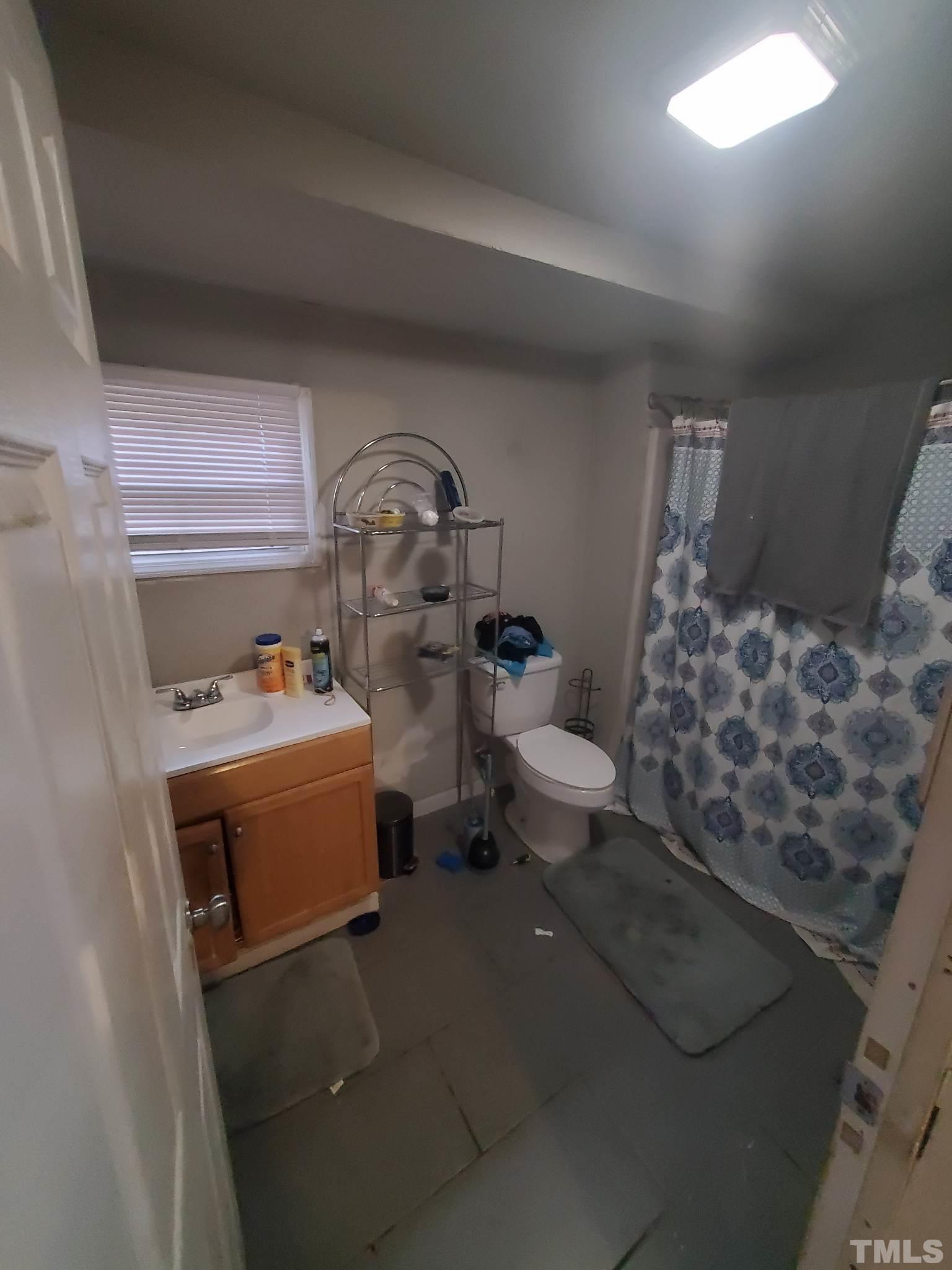 3600 Dearborn Drive Durham, NC 27704 - Photo 12 of 13 a bathroom with a toilet sink and mirror