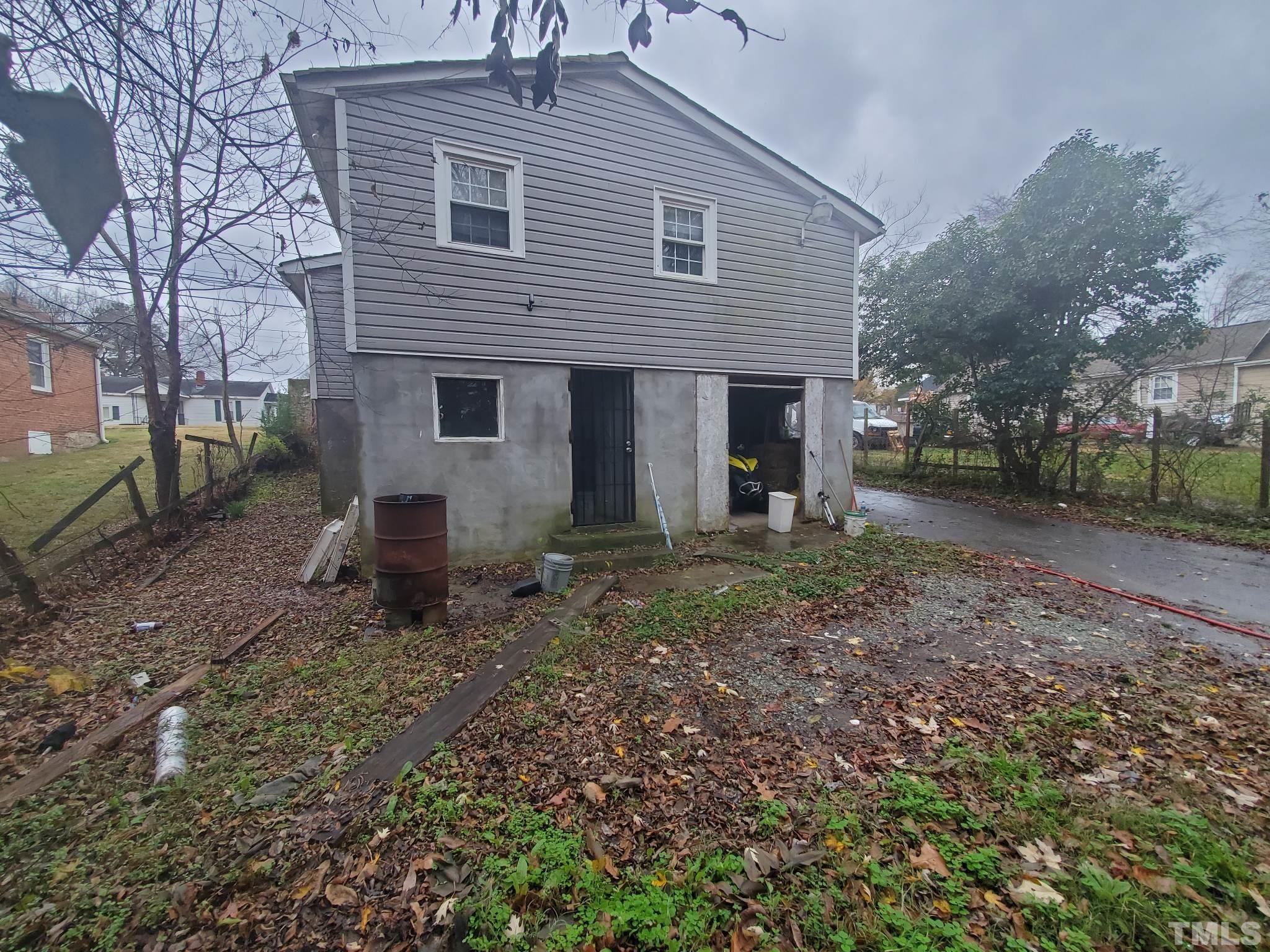 3600 Dearborn Drive Durham, NC 27704 - Photo 3 of 13 a view of a house with a yard and a tree
