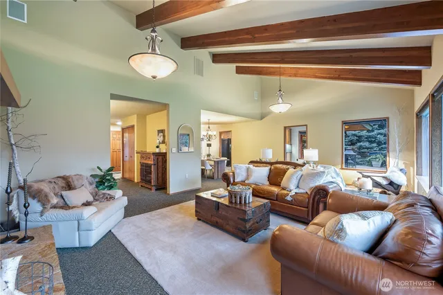 a living room with furniture and a chandelier