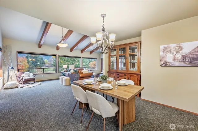a view of a dining room with furniture large window and outside view