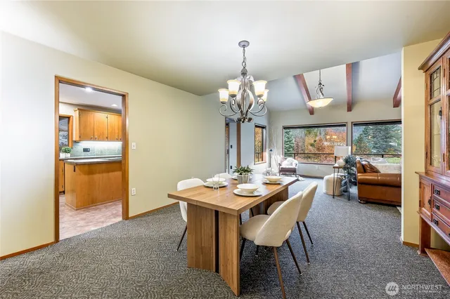 a view of a dining room with furniture and chandelier