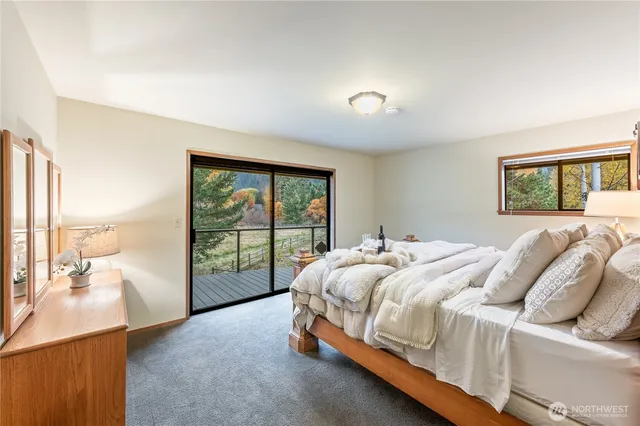 a bed sitting in a spacious bedroom next to a window