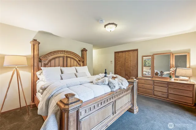 a bedroom with a bed and a mirror