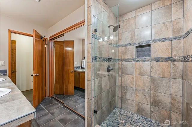 a bathroom with a glass shower door