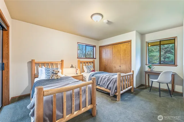 a bedroom with a bed and a table chair