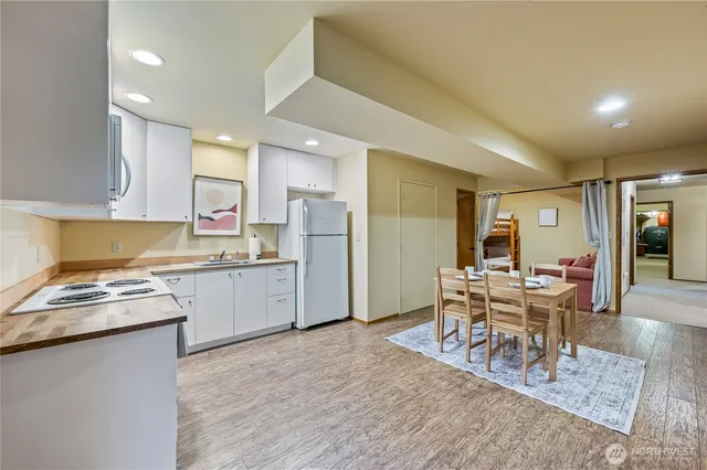 a kitchen with refrigerator and cabinets