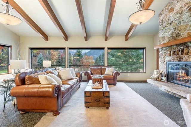a living room with furniture and a floor to ceiling window