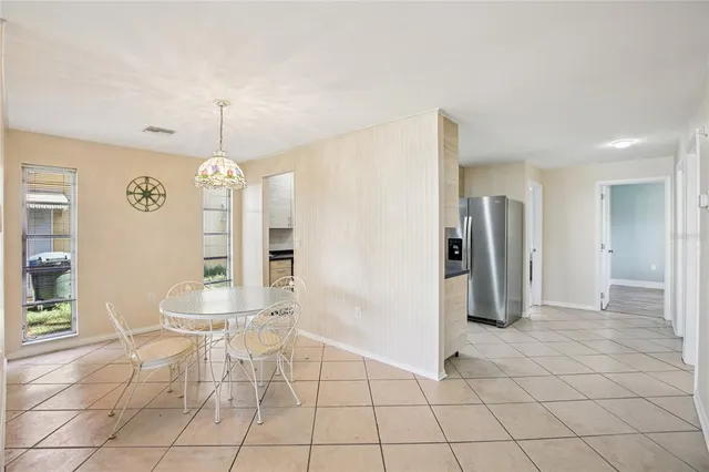 a bedroom with a large bed and a potted plant