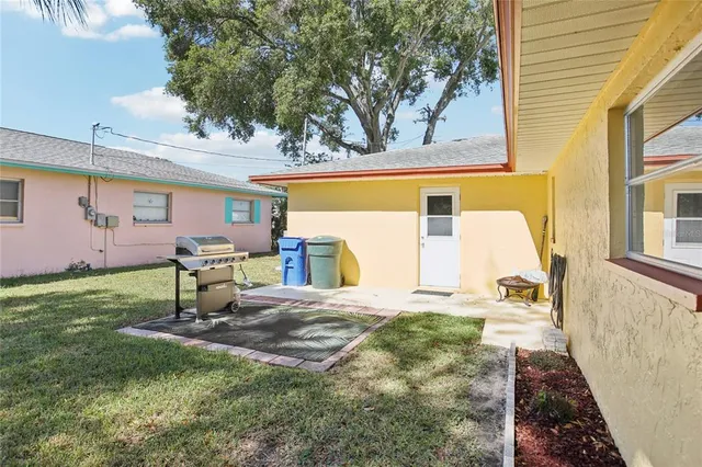 a front view of house with yard and trees in the background