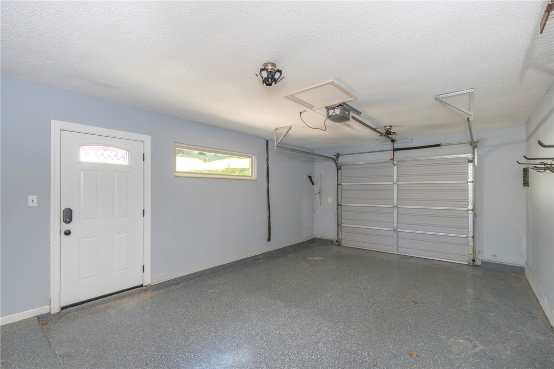 1302 Leeward Road Anderson, SC 29625 - Photo 42 of 50 Functional garage space with a durable epoxy floor finish, perfect for vehicles and storage.