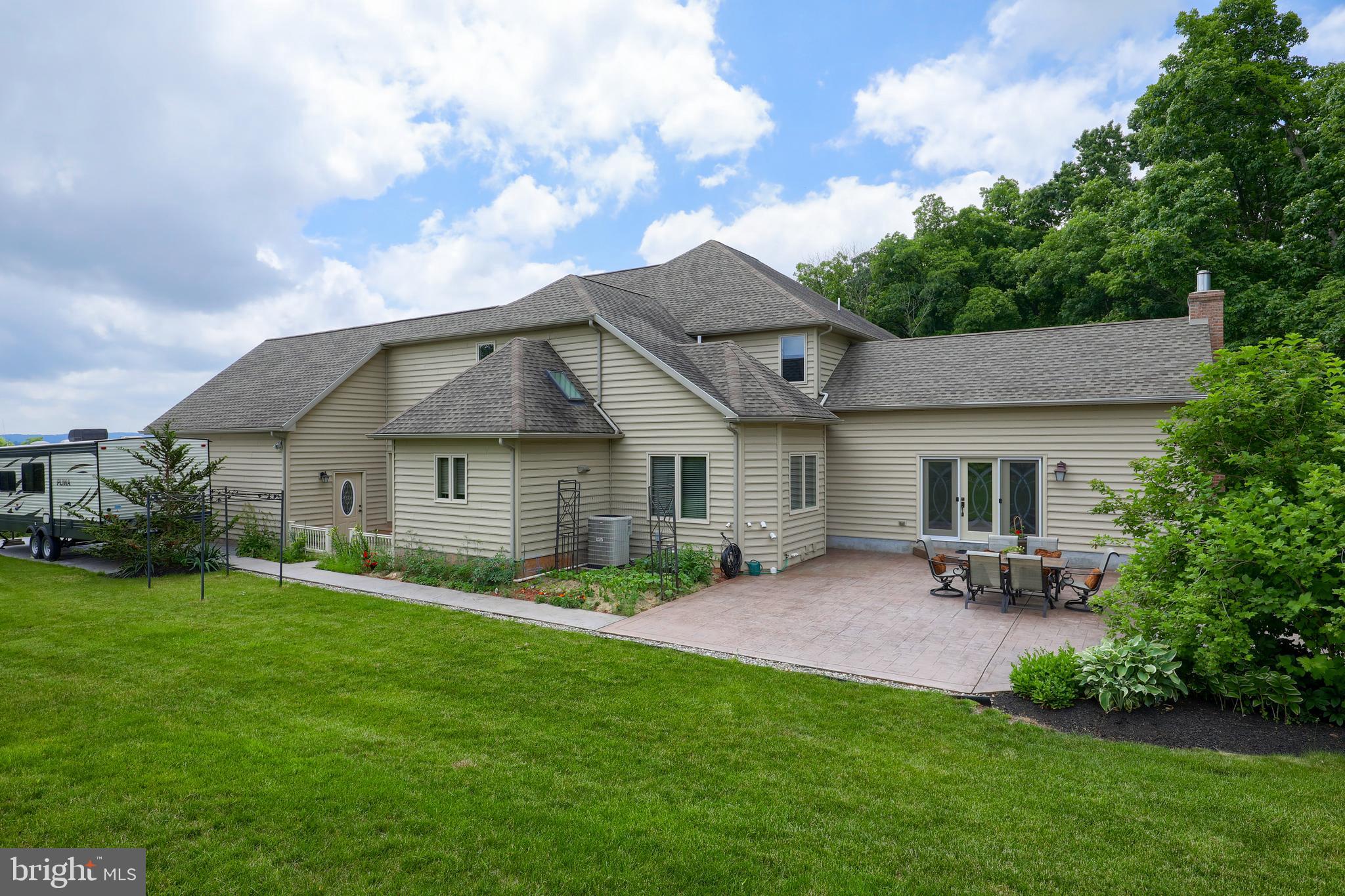 70 Horseshoe Trail Road Denver, PA 17517 - Photo 3 of 128 a view of a house with a yard and a garden