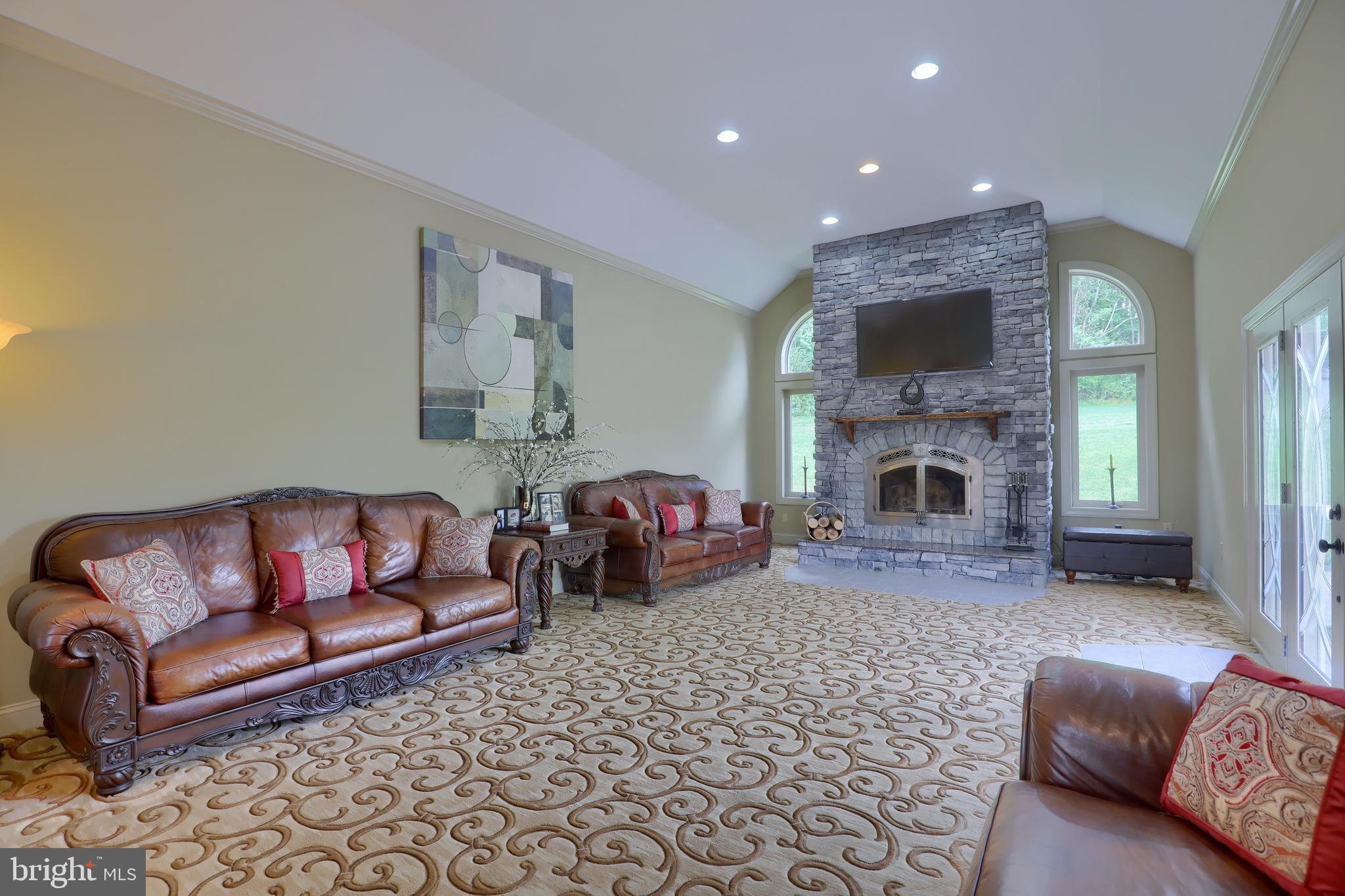 70 Horseshoe Trail Road Denver, PA 17517 - Photo 40 of 128 a living room with furniture a flat screen tv and a fireplace
