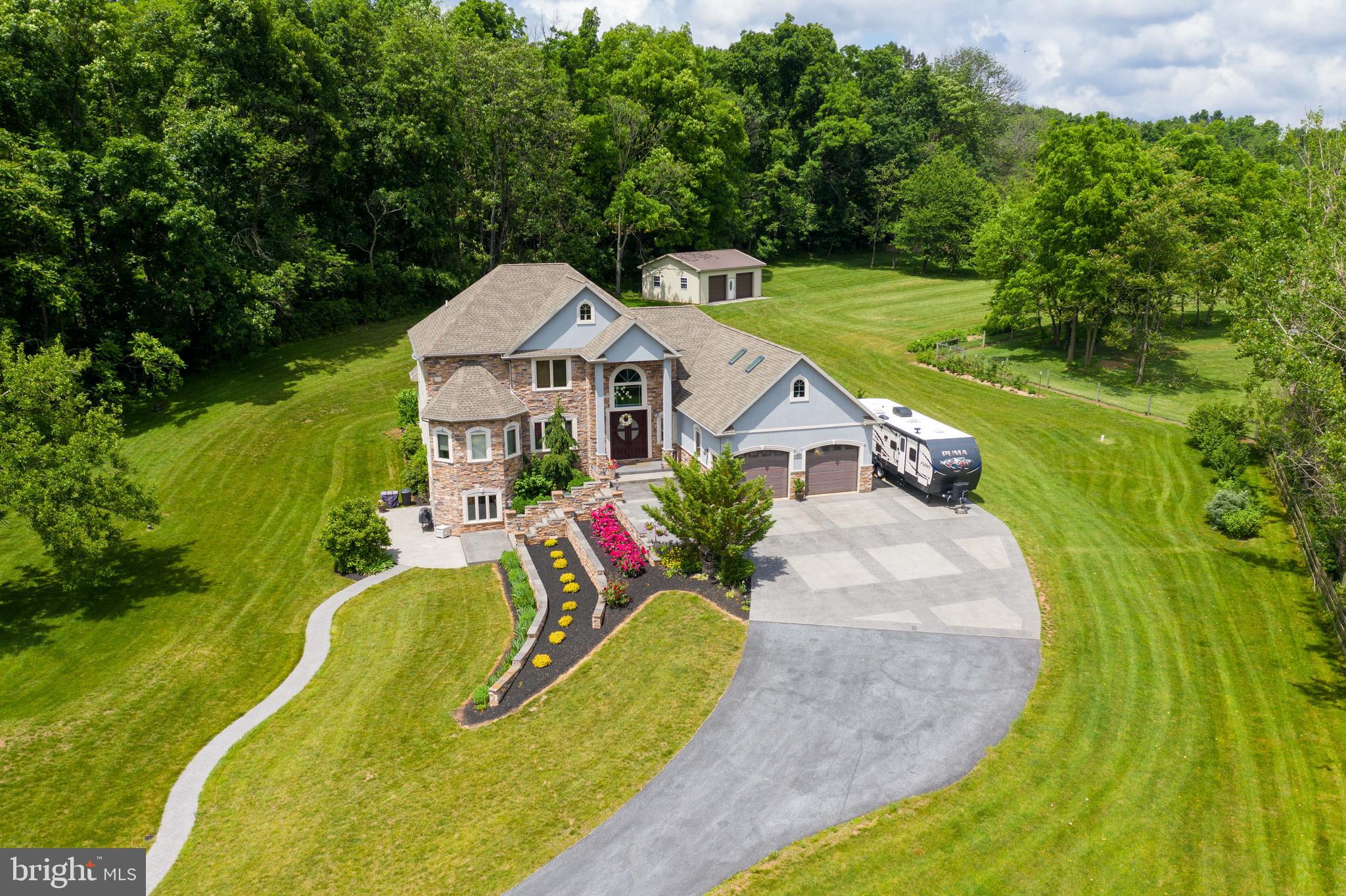 70 Horseshoe Trail Road Denver, PA 17517 - Photo 5 of 128 a view of a house with a big yard potted plants and large tree