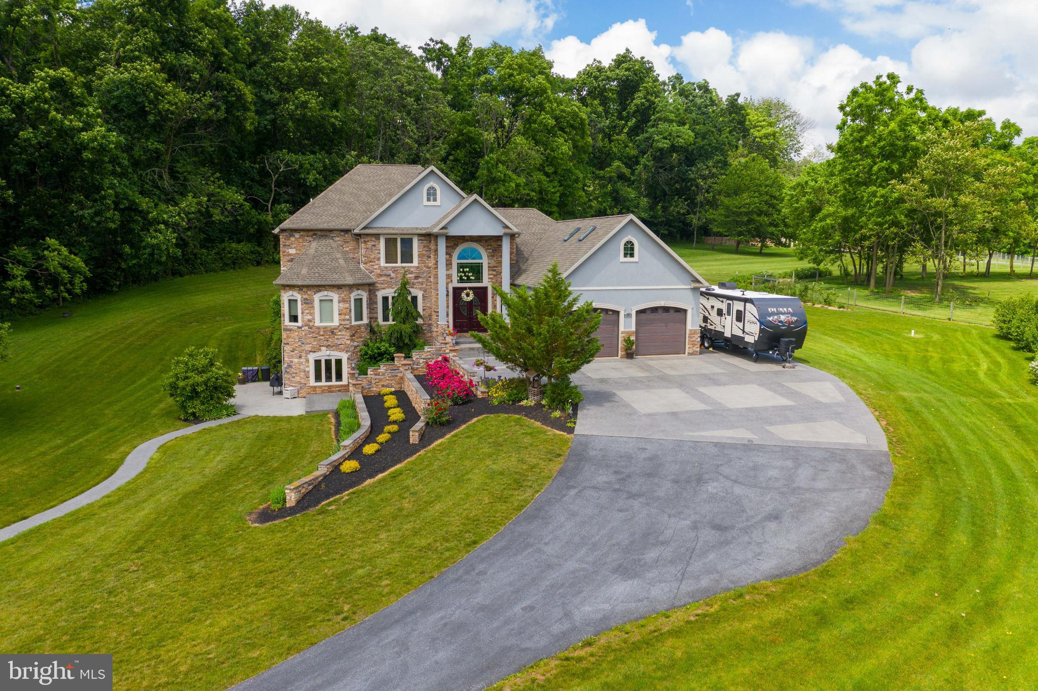 70 Horseshoe Trail Road Denver, PA 17517 - Photo 6 of 128 a front view of a house with garden