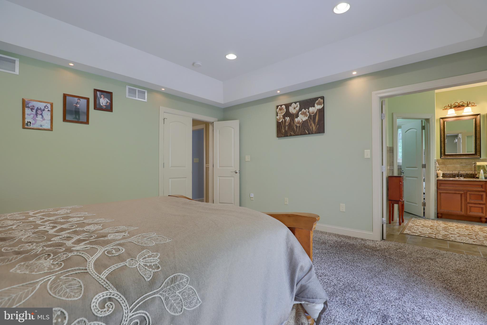 70 Horseshoe Trail Road Denver, PA 17517 - Photo 52 of 128 a bedroom with a large bed and a view of bathroom