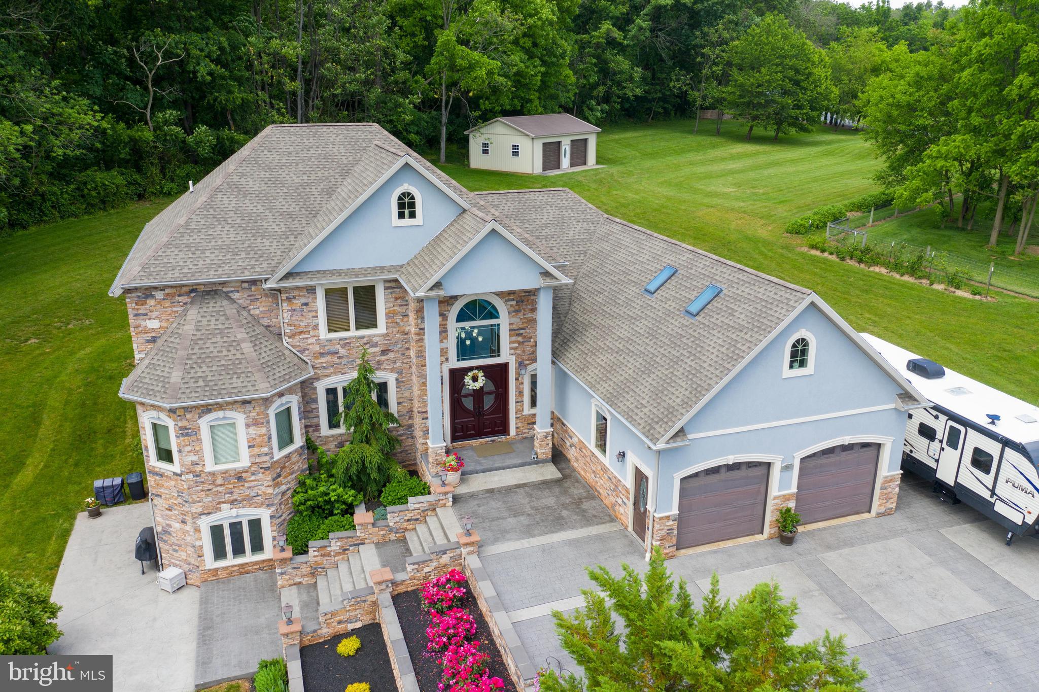 70 Horseshoe Trail Road Denver, PA 17517 - Photo 7 of 128 a aerial view of a house with a yard table and chairs