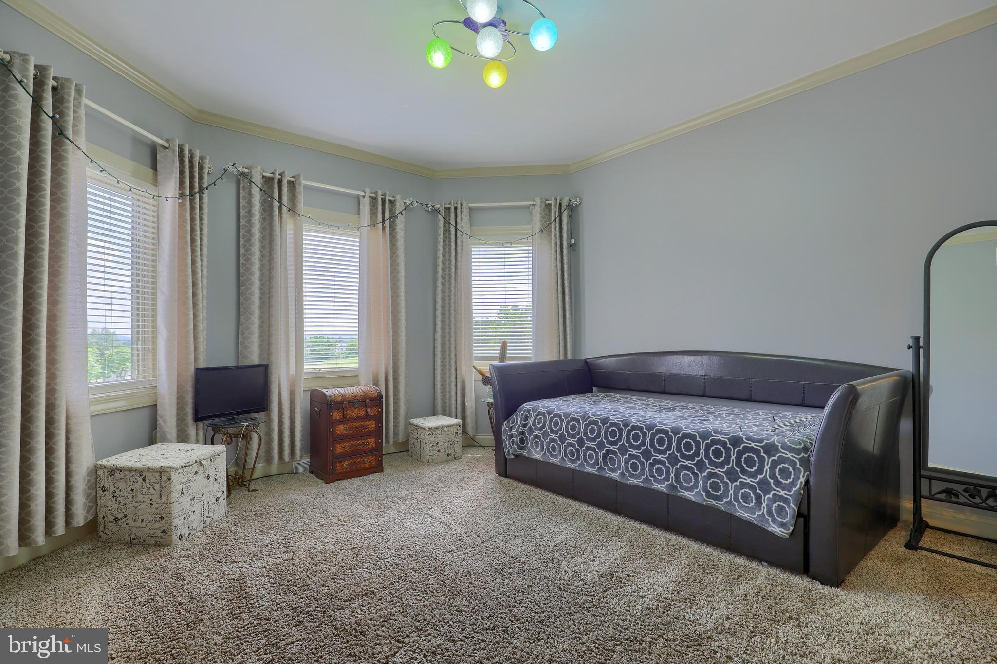 70 Horseshoe Trail Road Denver, PA 17517 - Photo 63 of 128 a bedroom with a bed and a chandelier