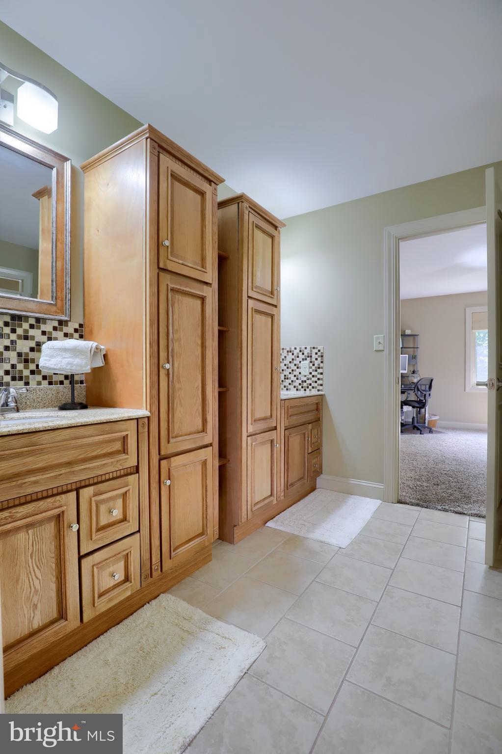 70 Horseshoe Trail Road Denver, PA 17517 - Photo 71 of 128 a spacious bathroom with a granite countertop sink a mirror and a refrigerator