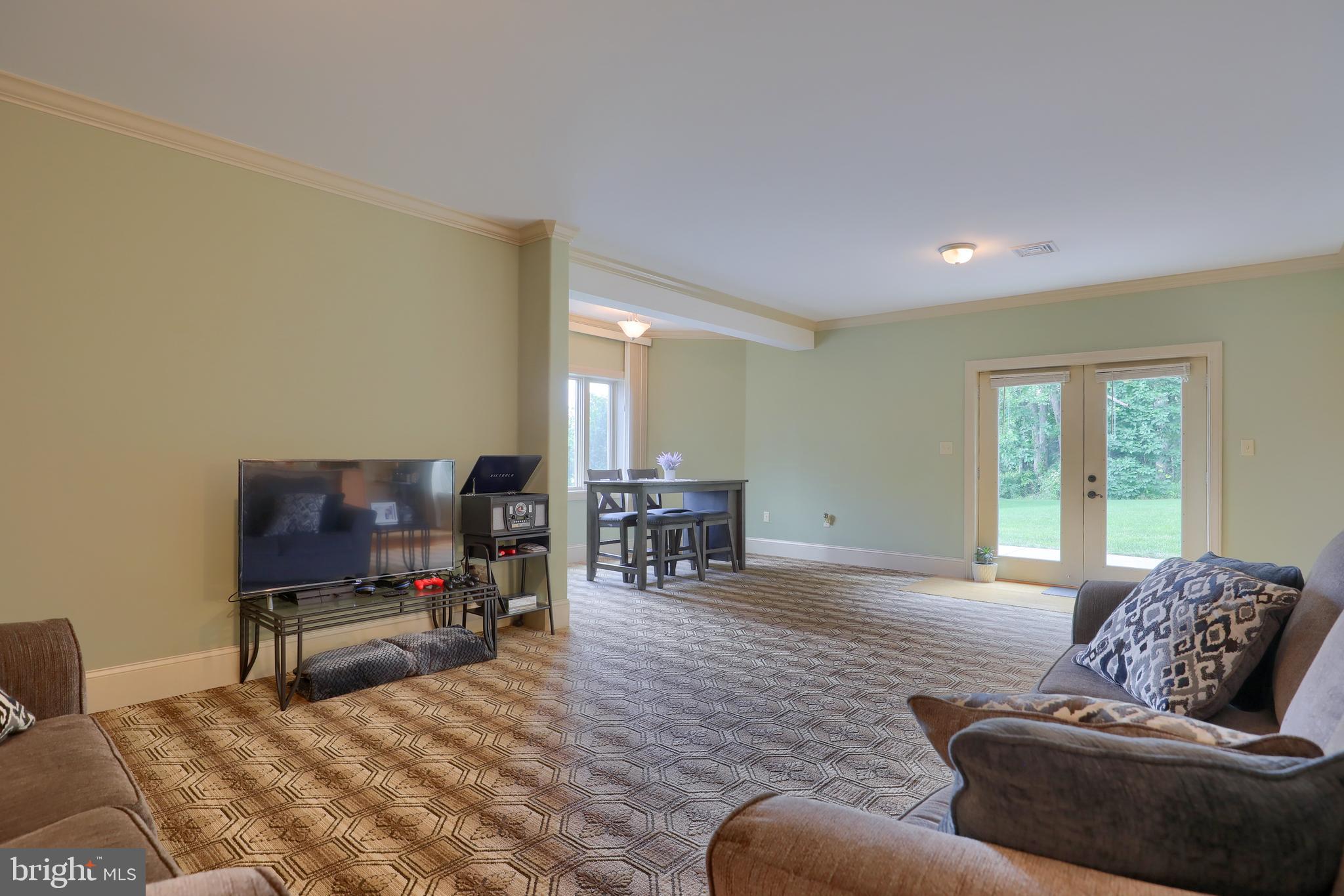70 Horseshoe Trail Road Denver, PA 17517 - Photo 91 of 128 a living room with furniture and a flat screen tv with kitchen view