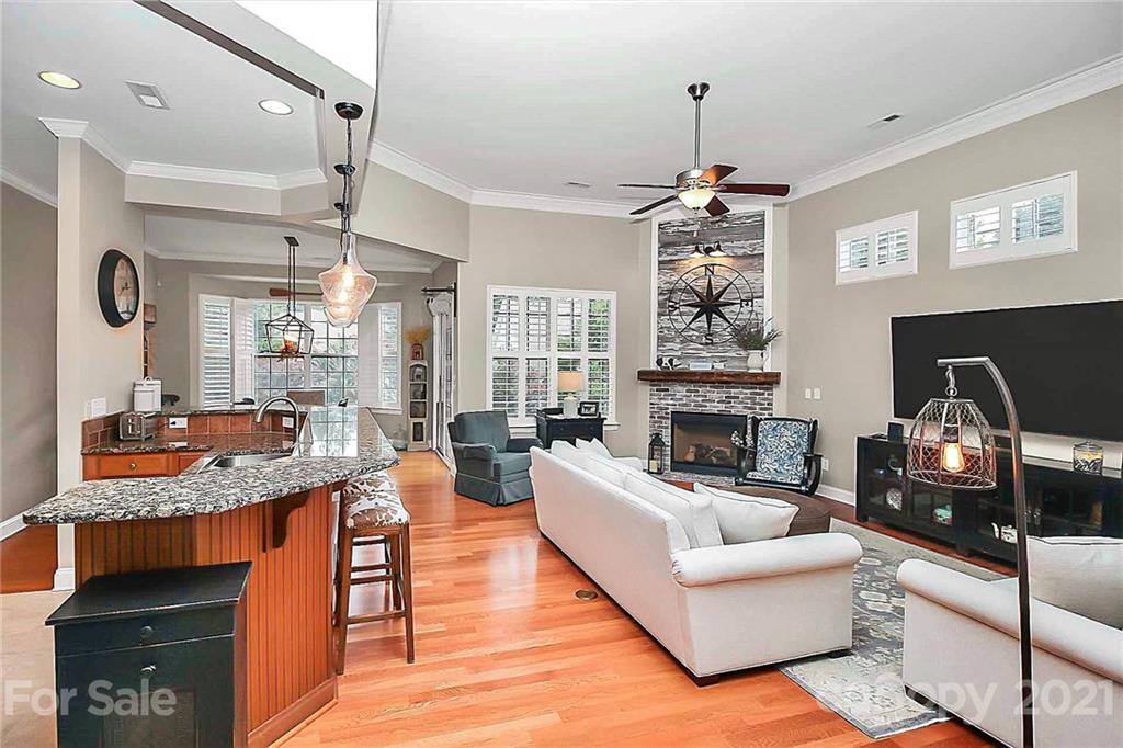 2018 Dynasty Court Fort Mill, SC 29708 - Photo 14 of 31 a living room with granite countertop furniture a fireplace a flat screen tv and windows