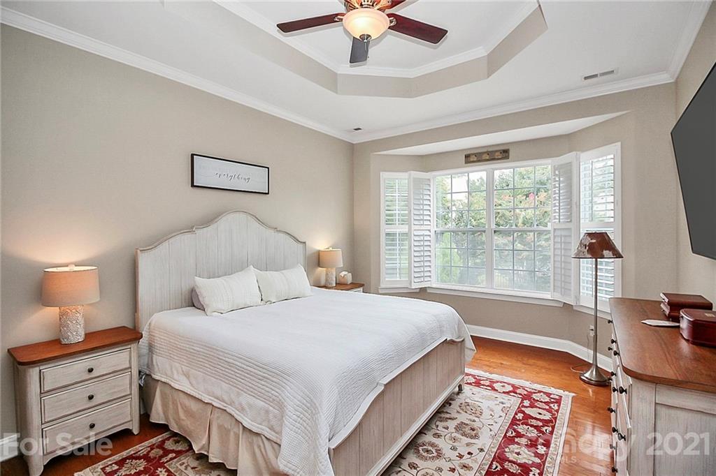 2018 Dynasty Court Fort Mill, SC 29708 - Photo 15 of 31 a bed room with a bed and a chandelier
