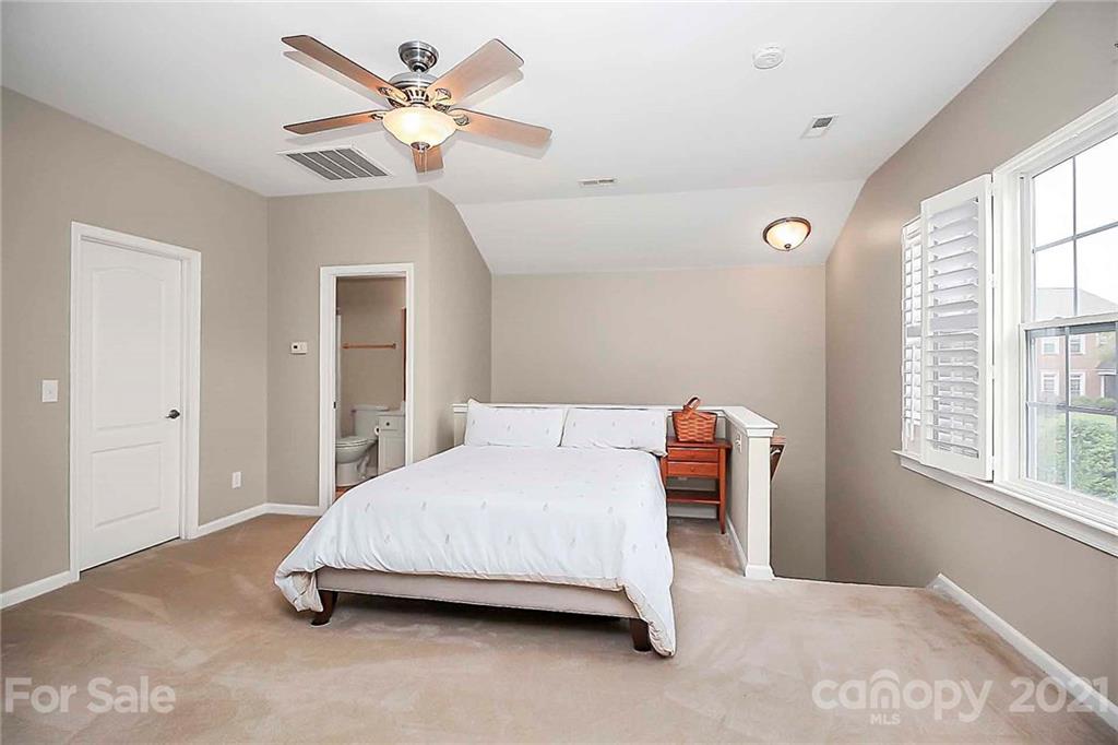 2018 Dynasty Court Fort Mill, SC 29708 - Photo 23 of 31 a bedroom with a bed and a chandelier