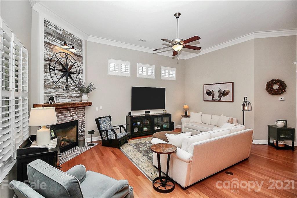 2018 Dynasty Court Fort Mill, SC 29708 - Photo 6 of 31 a living room with furniture a fireplace and a flat screen tv