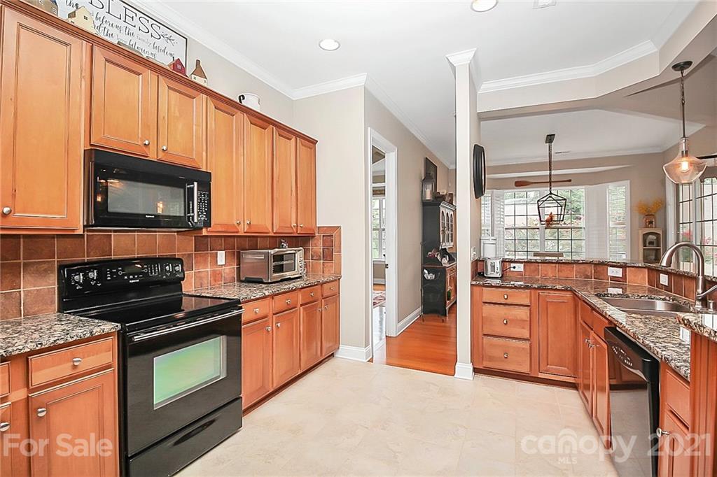2018 Dynasty Court Fort Mill, SC 29708 - Photo 8 of 31 a kitchen with stainless steel appliances granite countertop a stove top oven a sink dishwasher a refrigerator and a microwave
