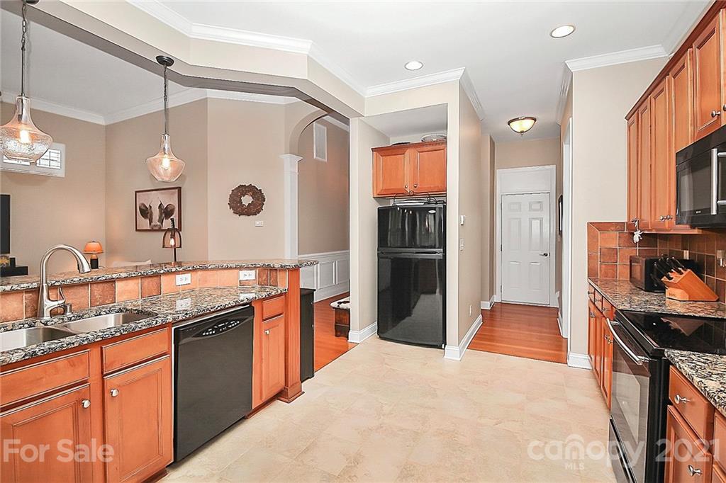 2018 Dynasty Court Fort Mill, SC 29708 - Photo 9 of 31 a kitchen with stainless steel appliances granite countertop a sink and wooden cabinets