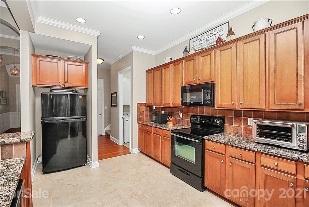 2018 Dynasty Court Fort Mill, SC 29708 - Photo 10 of 31 a kitchen with stainless steel appliances granite countertop a refrigerator a stove and a sink with wooden floor