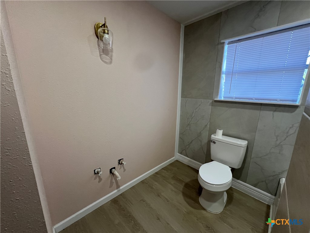 1009 Oak Street Refugio, TX 78377 - Photo 12 of 22 a white toilet sitting next to a sink