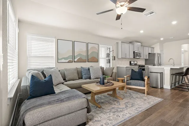 a living room with furniture and kitchen view