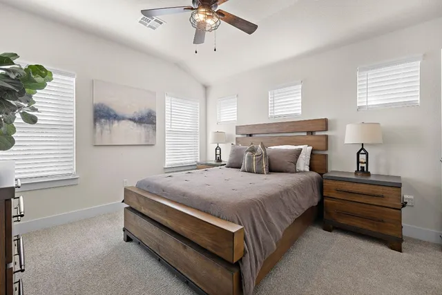 a bed room with a bed and a chandelier