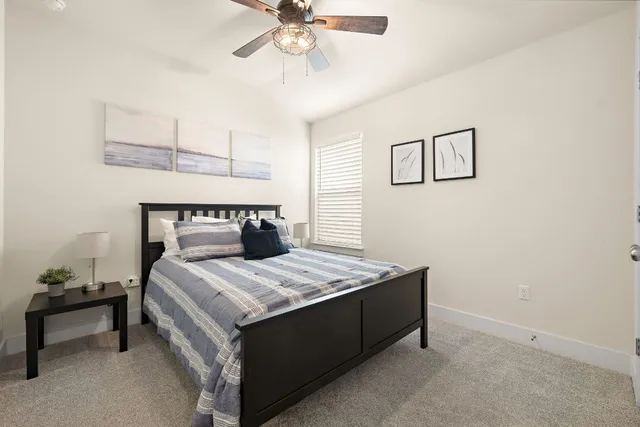 a bedroom with a bed and a table