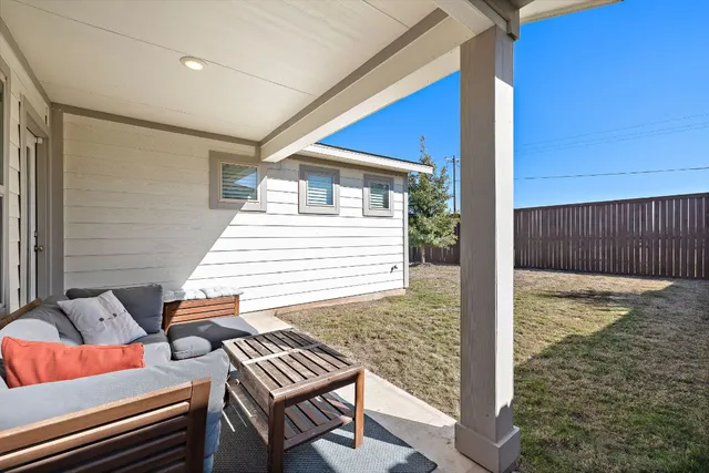 a view of a balcony with two chairs and a table