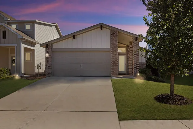 a front view of house with a garden