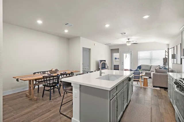 a view of a dining room with furniture and wooden floor