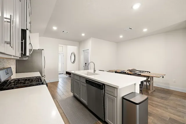 a kitchen with a sink stove and refrigerator