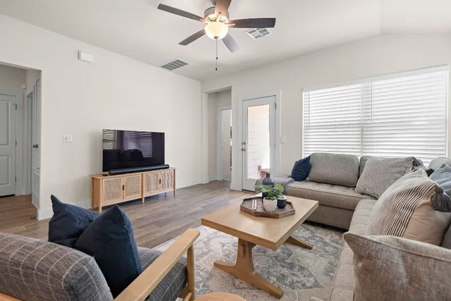a living room with furniture and a flat screen tv