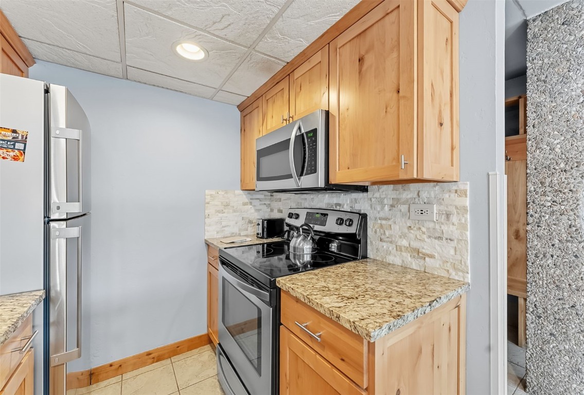 601 Village Road, Unit 501 Breckenridge, CO 80424 - Photo 11 of 50 a kitchen with stainless steel appliances granite countertop a refrigerator and a stove top oven
