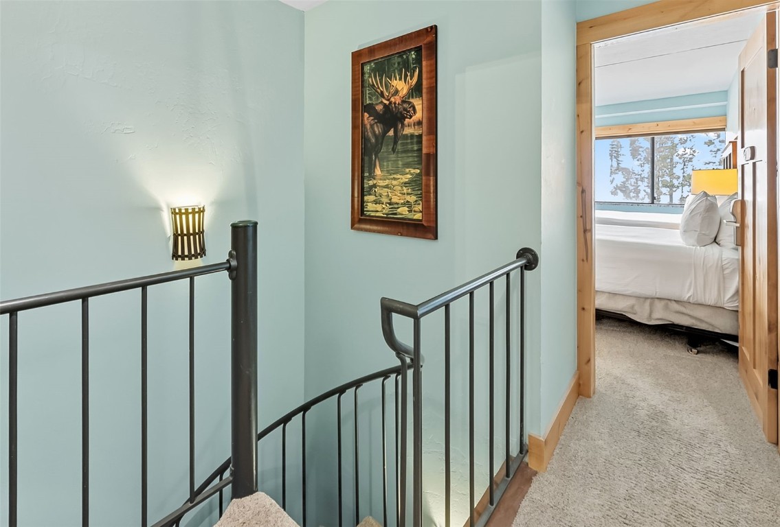 601 Village Road, Unit 501 Breckenridge, CO 80424 - Photo 19 of 50 a view of a hallway with bedroom and stairs