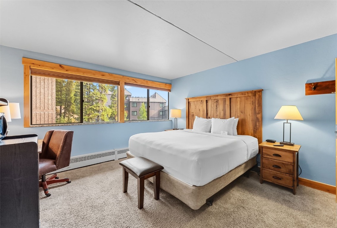 601 Village Road, Unit 501 Breckenridge, CO 80424 - Photo 28 of 50 a bedroom with a bed a table and a stool