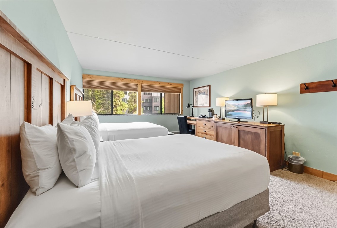 601 Village Road, Unit 501 Breckenridge, CO 80424 - Photo 30 of 50 a bed room with a bed and a chair