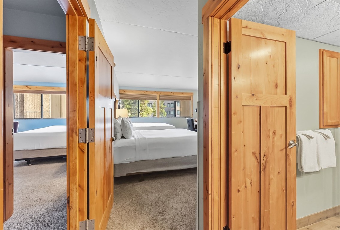 601 Village Road, Unit 501 Breckenridge, CO 80424 - Photo 33 of 50 a bedroom with a bed and a glass door