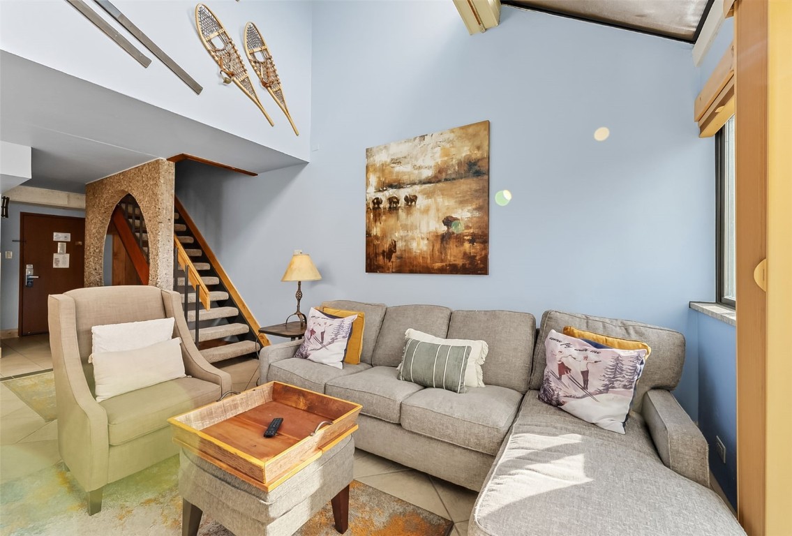 601 Village Road, Unit 501 Breckenridge, CO 80424 - Photo 4 of 50 a living room with furniture and a stairs