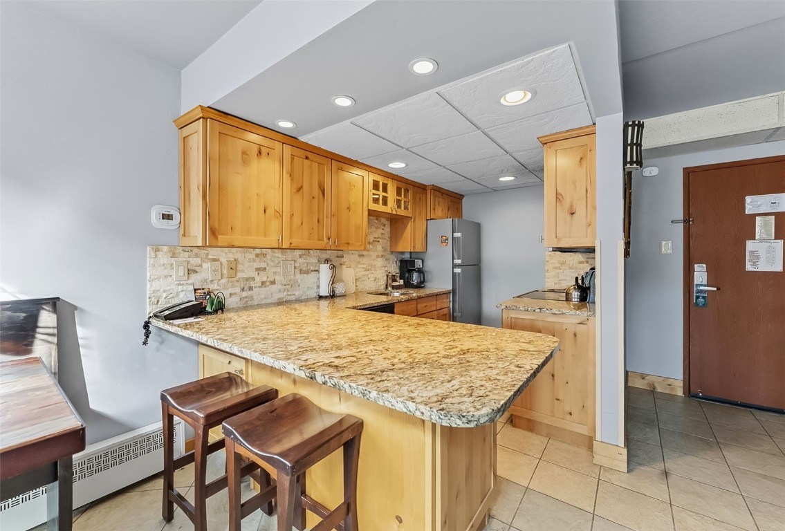 601 Village Road, Unit 501 Breckenridge, CO 80424 - Photo 7 of 50 a kitchen with a table and chairs in it