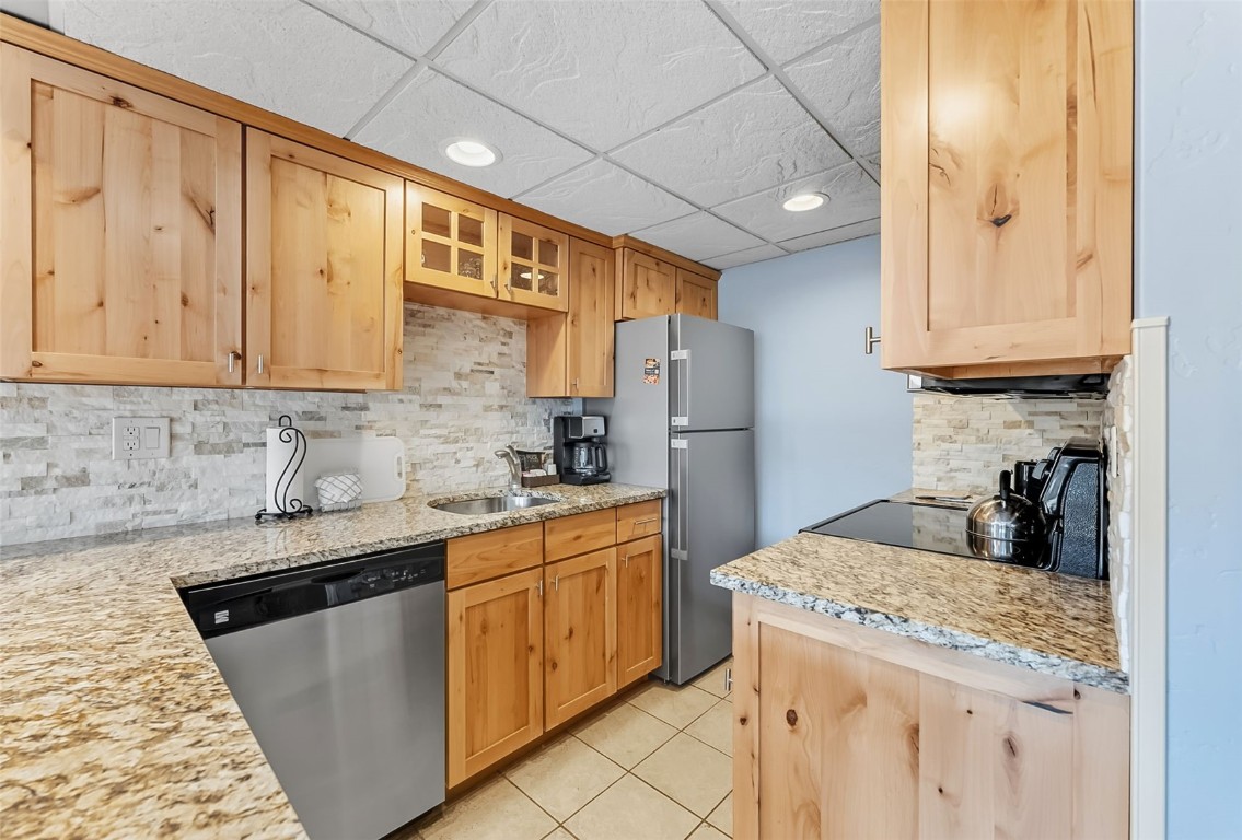 601 Village Road, Unit 501 Breckenridge, CO 80424 - Photo 9 of 50 a kitchen with stainless steel appliances granite countertop a sink stove and refrigerator
