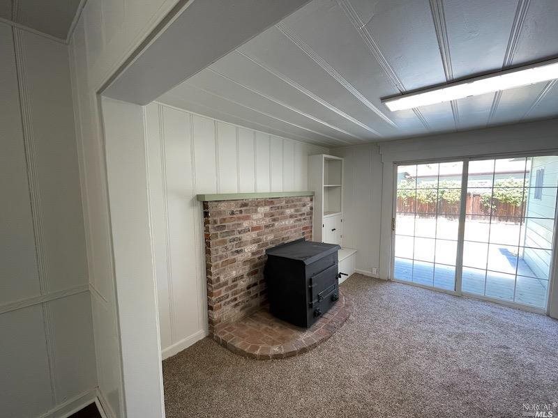 5773 Melita Road Santa Rosa, CA 95409 - Photo 3 of 13 a view of an empty room with a fireplace and a window
