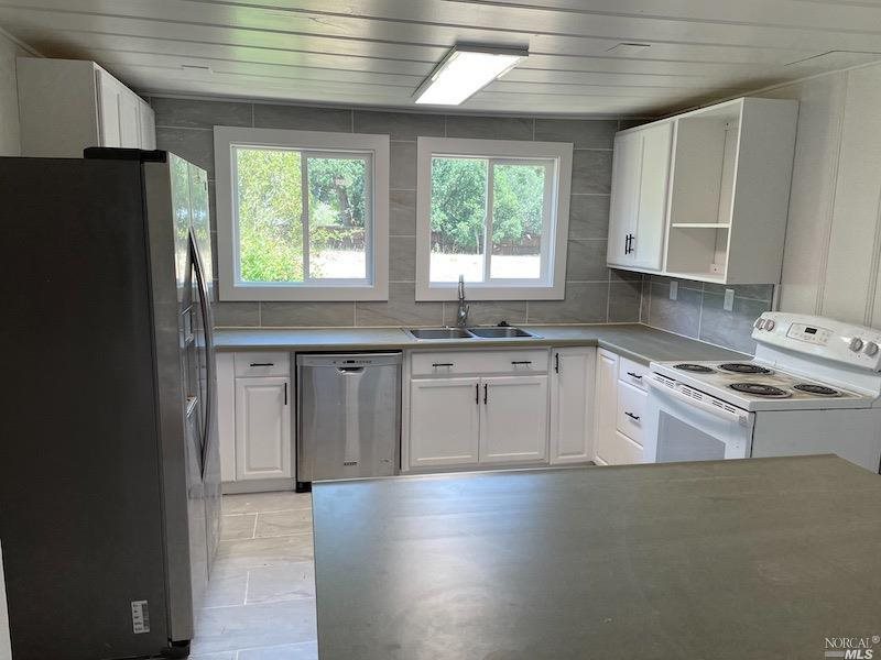 5773 Melita Road Santa Rosa, CA 95409 - Photo 5 of 13 a kitchen with stainless steel appliances granite countertop a stove a sink dishwasher and a refrigerator